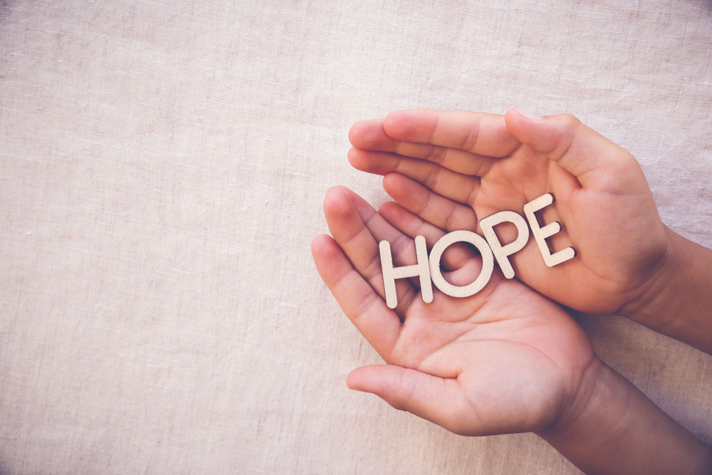 HOPE letters in Hands